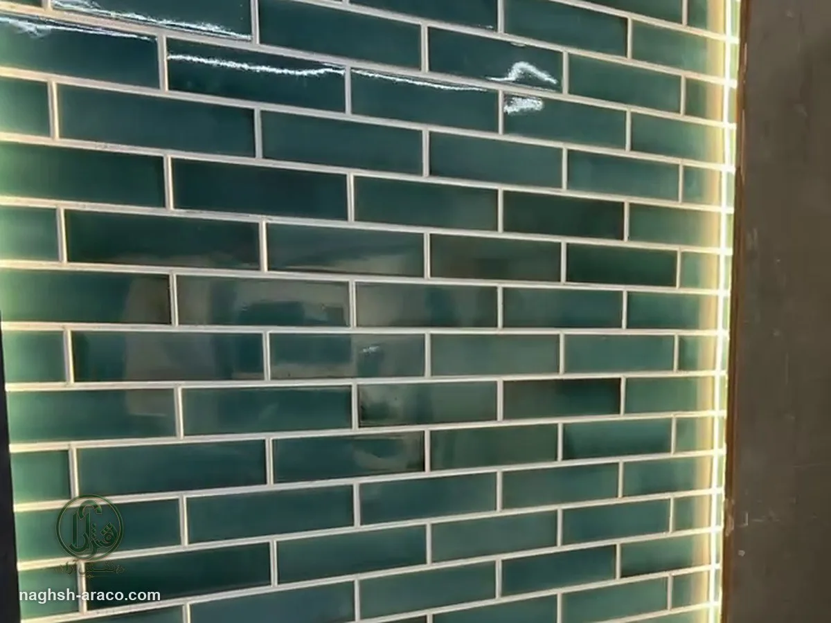 Backlit green subway tile wall behind a bathtub