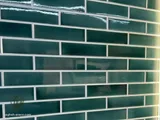 Backlit green subway tile wall behind a bathtub (5)